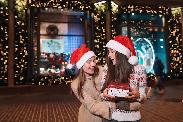 Portrait of happy cute young friends hugging each other