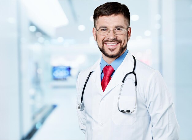 Portrait of happy doctor with stethoscope looking at camera