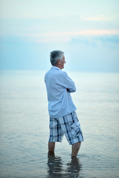 Portrait of happy elderly man at sea