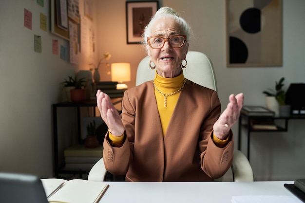 portrait of happy elderly woman giving presentation