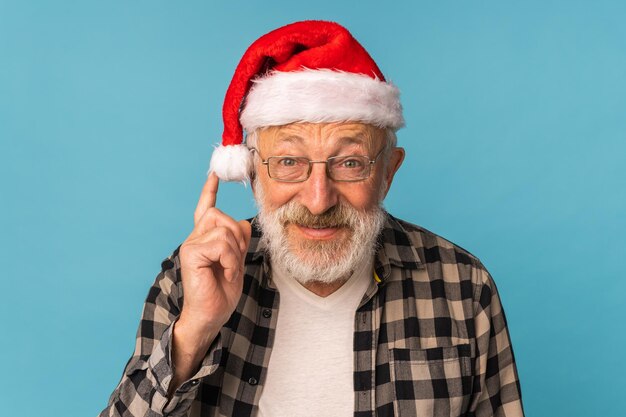 Portrait of happy emotions santa claus excited looking at camera on blue background