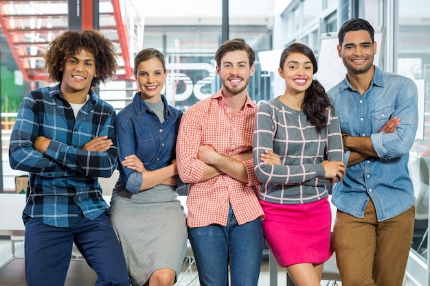 Portrait of happy executives leaning with arms crossed