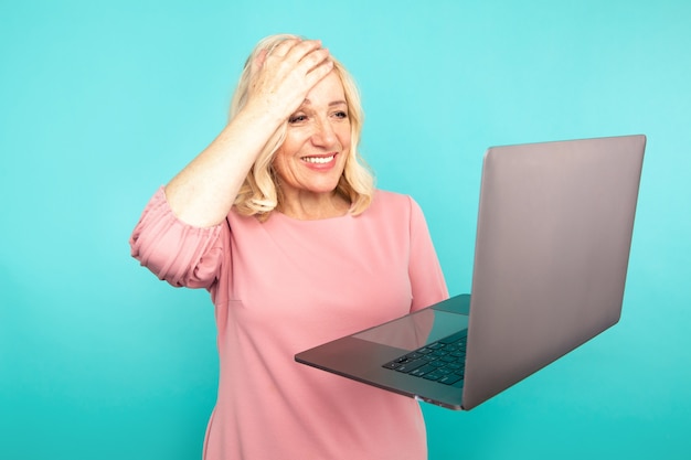 Photo portrait of happy exited abult lady with laptop isolated