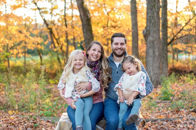 Photo portrait of happy family against trees during autumn