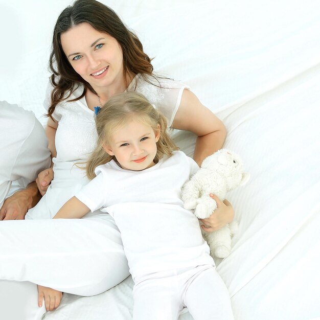 Portrait of a happy family on the bed in the bedroom.the concept of parenthood.