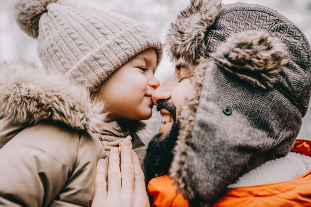 Portrait of happy family Father and baby daughter on Winter Vacation in park Happy joyful family