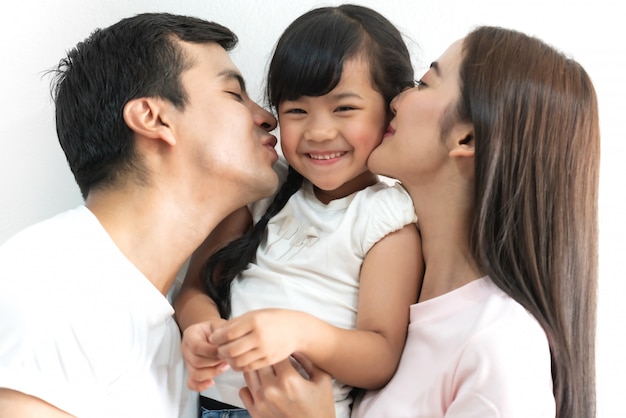 Portrait of happy family father and mother with daughter on white isolated