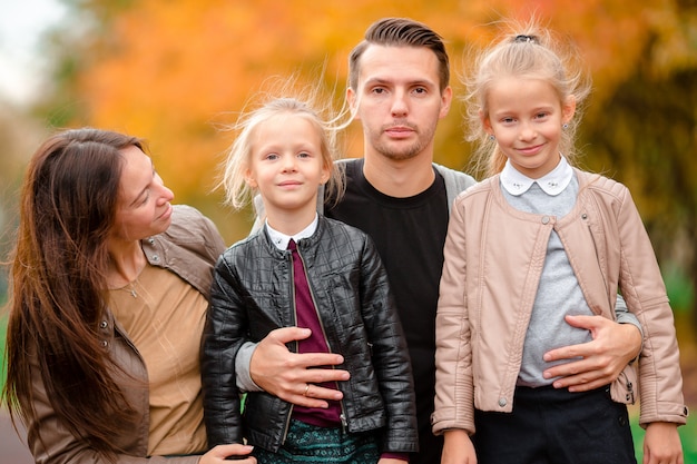 Portrait of happy family of four in autumn day