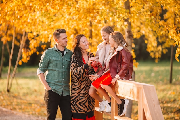 Portrait of happy family of four in autumn