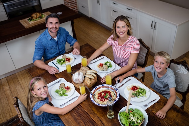 Photo portrait of happy family having meal in kitchen