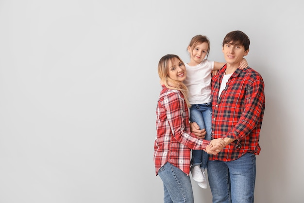 Portrait of happy family on light surface