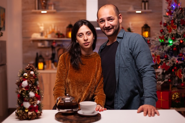 Portrait of happy family looking into camera while celebrating christmas winter holiday