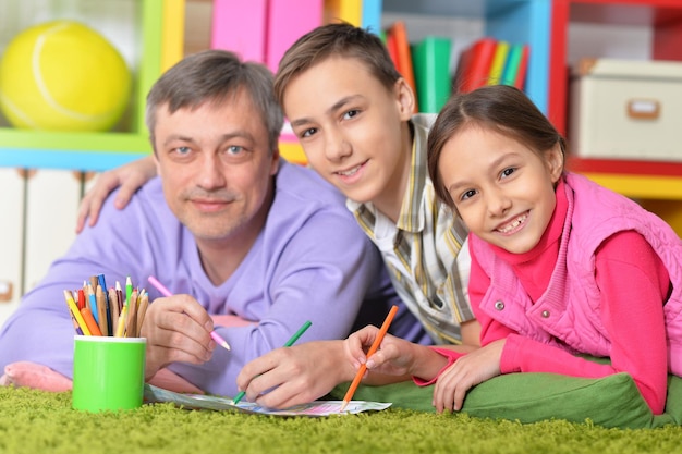 Portrait of happy family lying on floor