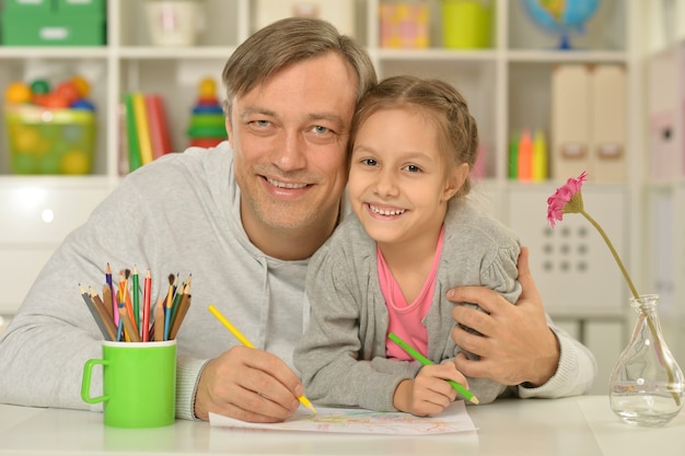 Portrait of happy family painting at home