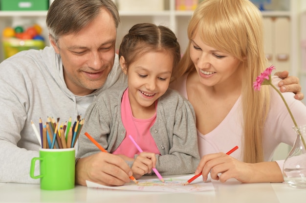 Portrait of happy family painting at home