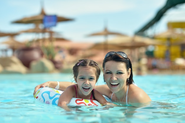 Portrait of a happy family relax in the pool