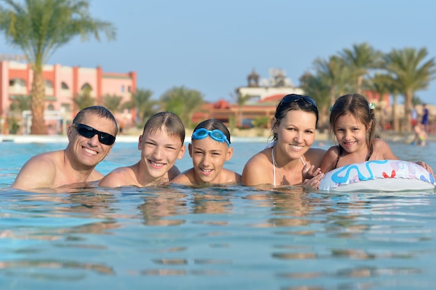 Portrait of a happy family relax in the pool