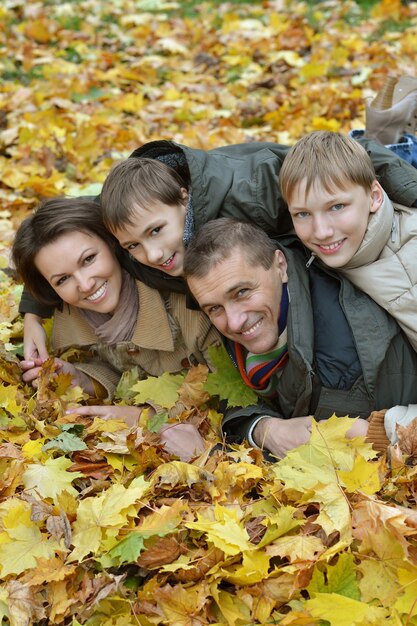 Portrait of happy family relaxing in autumn park