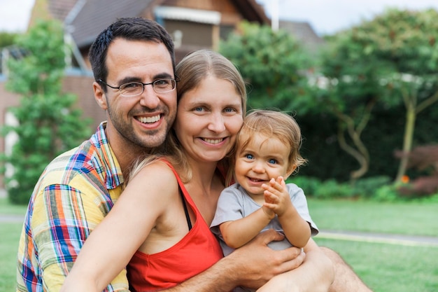 Portrait of happy family sitting at park