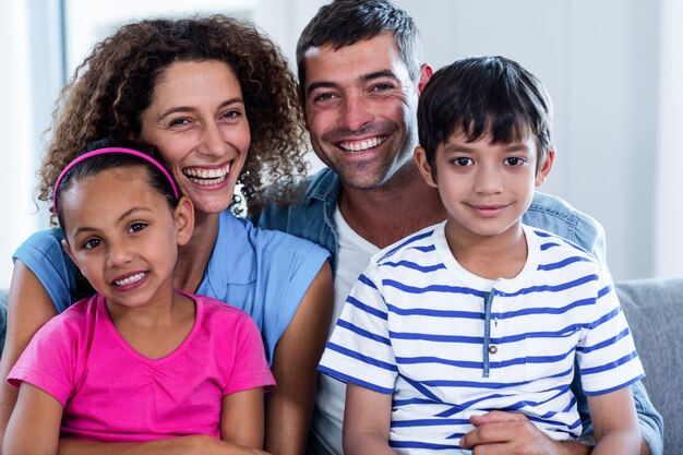 Portrait of happy family sitting together on sofa