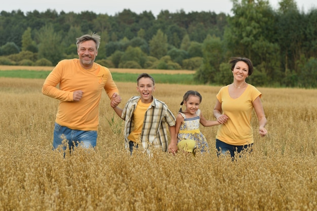 Portrait of a happy family at summer field