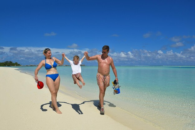 Photo portrait of a happy family on summer vacation  at beach