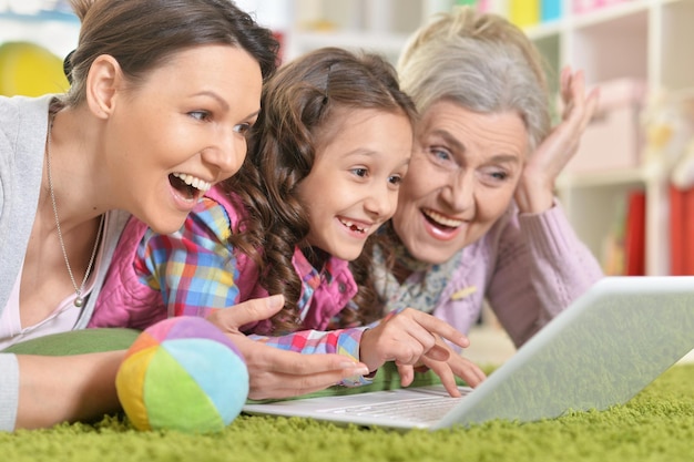 Portrait of happy family using laptop at home