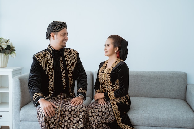 Portrait of a happy family wearing traditional Javanese clothes