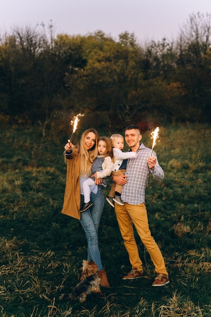 A portrait of a happy family which are playing in sunset