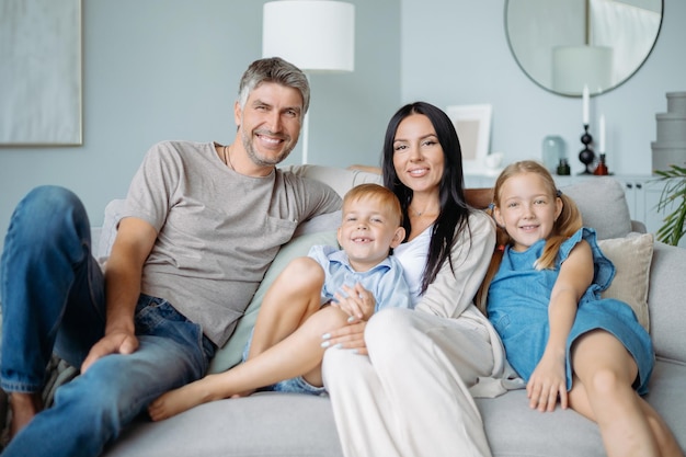 Portrait of a happy family with children sitting on the sofa