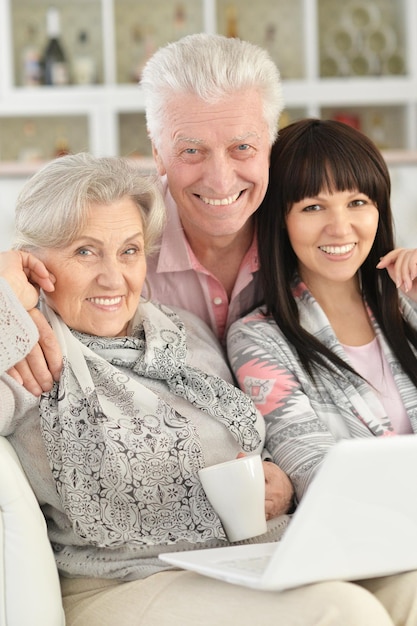 Portrait of happy family with laptop at home