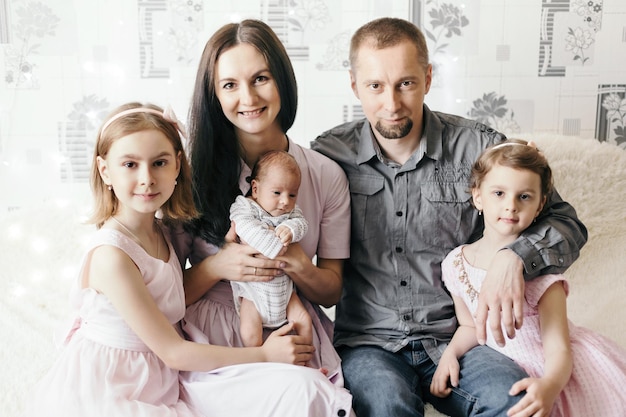 Photo portrait of a happy family with three children