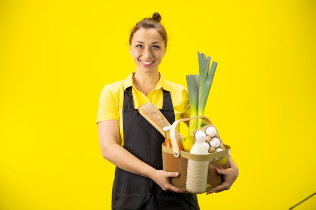 Portrait of happy farmer with basket of bio groceries and organic farm products