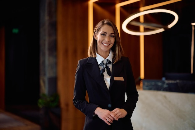 Portrait of happy female hotel manager looking at camera