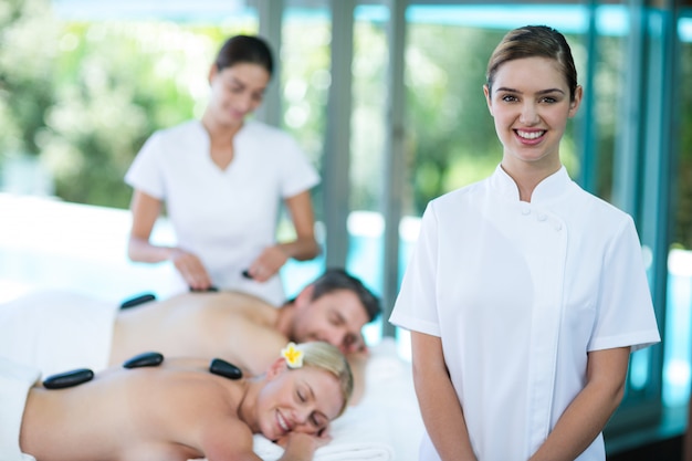 Portrait of happy female masseur in spa