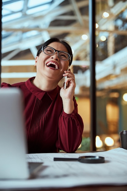 Portrait of happy female that talking per telephone