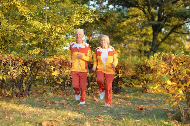 Portrait of happy fit senior couple jogging