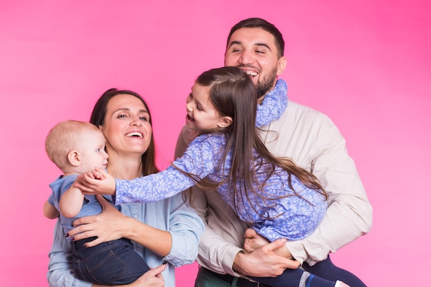 Portrait of happy friends against colored background