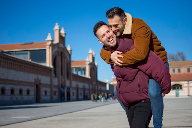 A portrait of happy gay couple outdoors in a sunny day