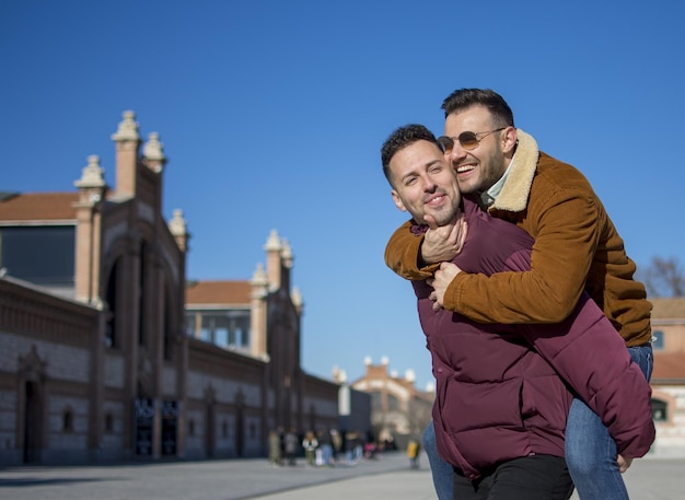 A portrait of happy gay couple outdoors in a sunny day