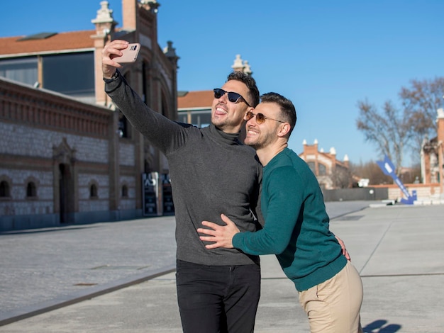 A portrait of happy gay couple outdoors