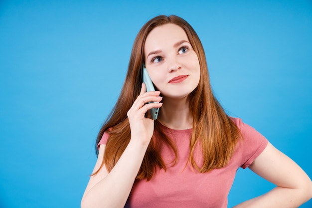 Portrait of happy ginger girl talking on the phone