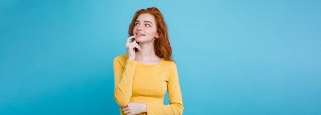 Photo portrait of happy ginger red hair girl with freckles smiling looking at camera pastel blue                                person