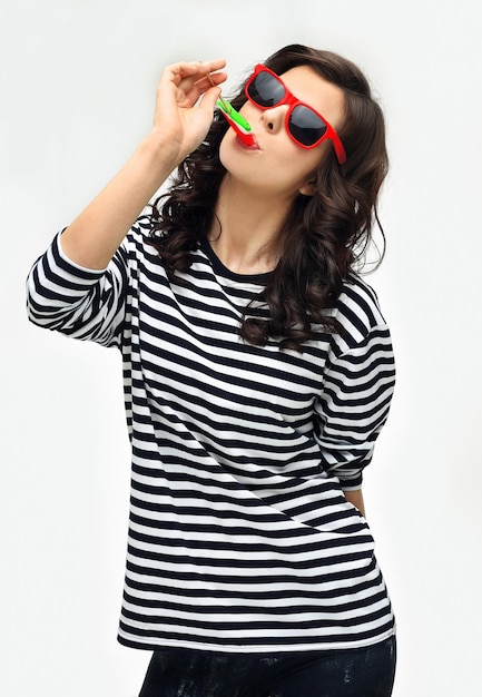 Portrait of happy girl laughing at camera holding big lollipop