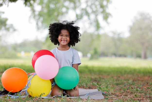 Photo portrait of happy girl playing with balloons