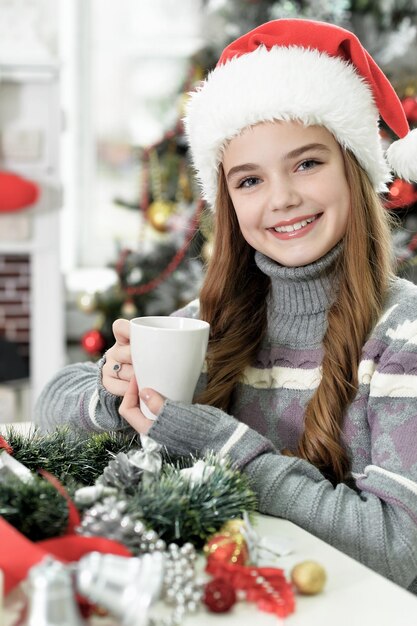 Portrait of happy girl in Santa hat