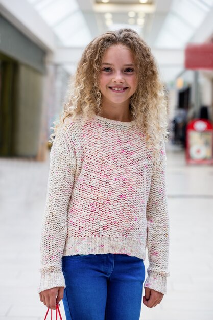 Portrait of happy girl standing in a corridor