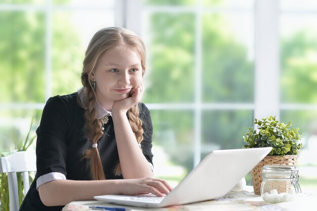 Portrait of a happy girl using laptop