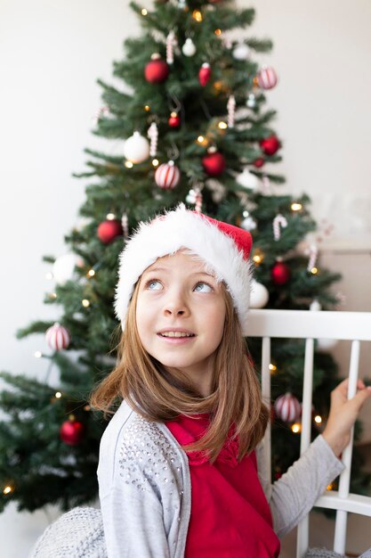 Photo portrait of happy girl with christmas tree