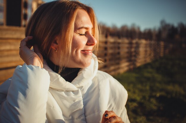 Portrait of a happy girl with a satisfied smile and closed eyes. 